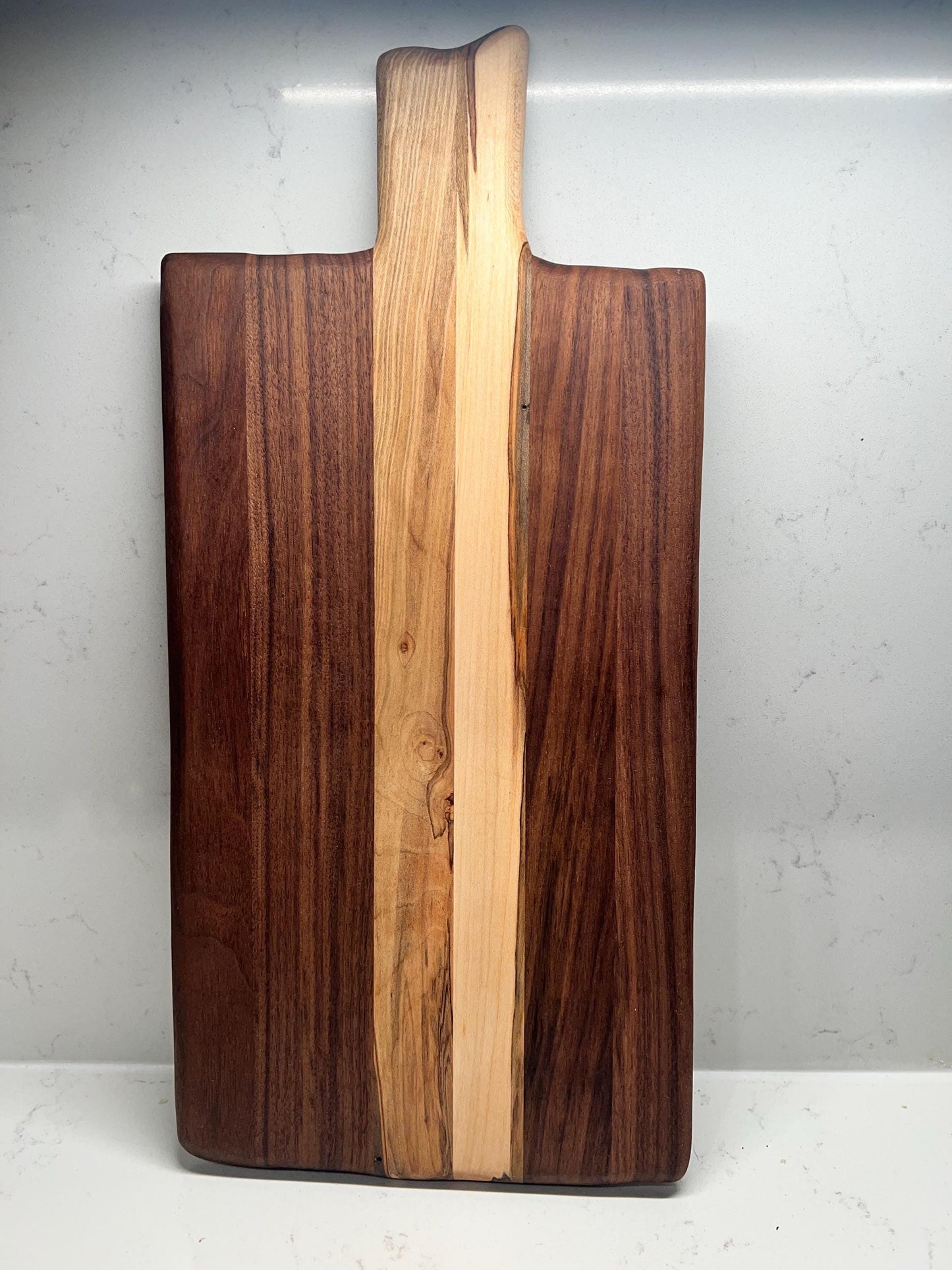Walnut charcuterie board with maple accents