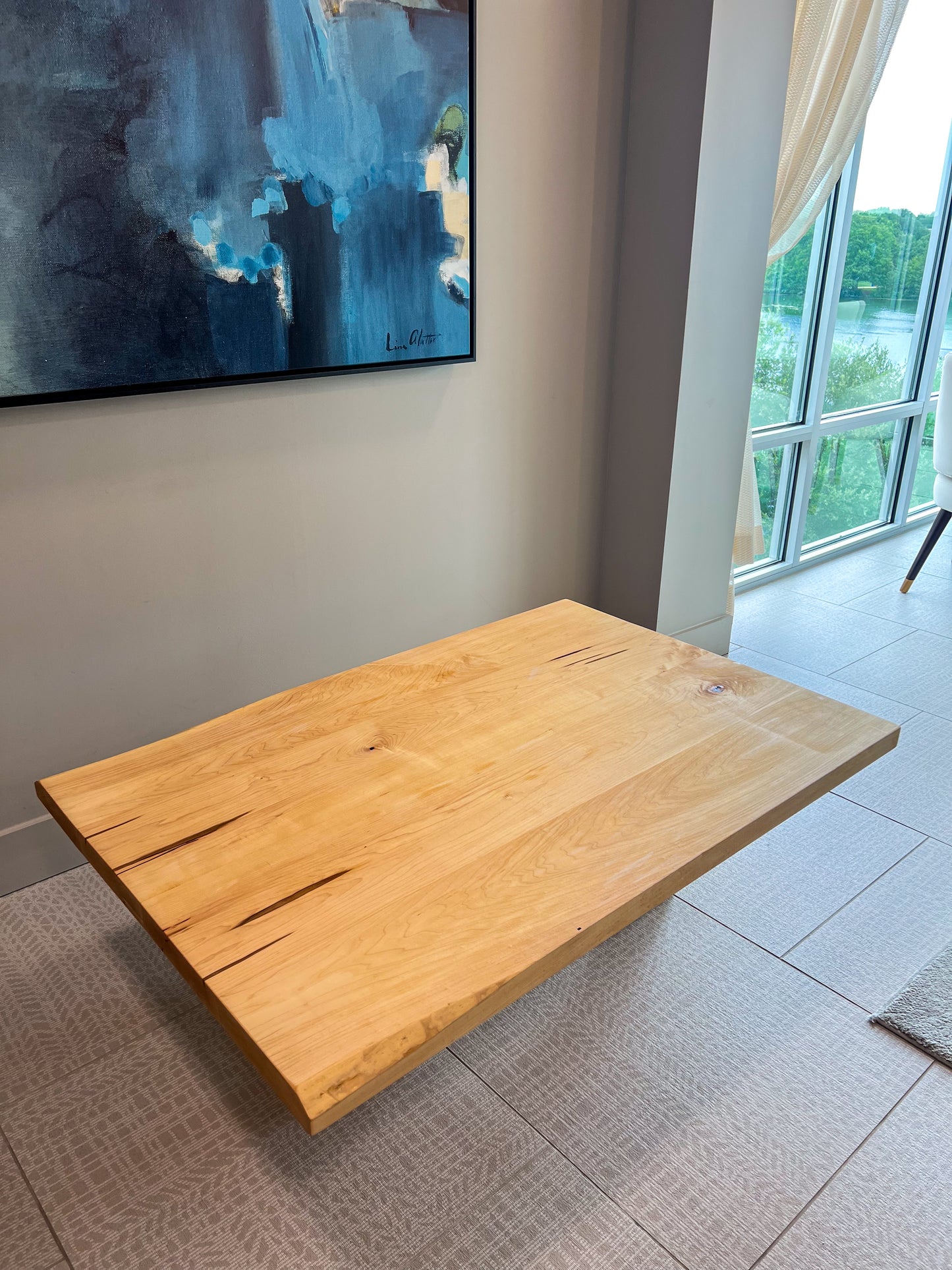 Handcrafted Japanese floor table made from solid wood with a live edge design. A low dining table perfect for tea, family meals, or modern spaces. Sustainable, custom-made furniture from Austin, Texas with timeless artisan style.
