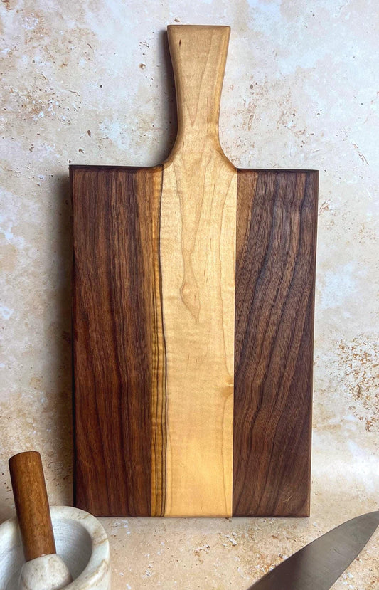 Walnut charcuterie board with maple accents
