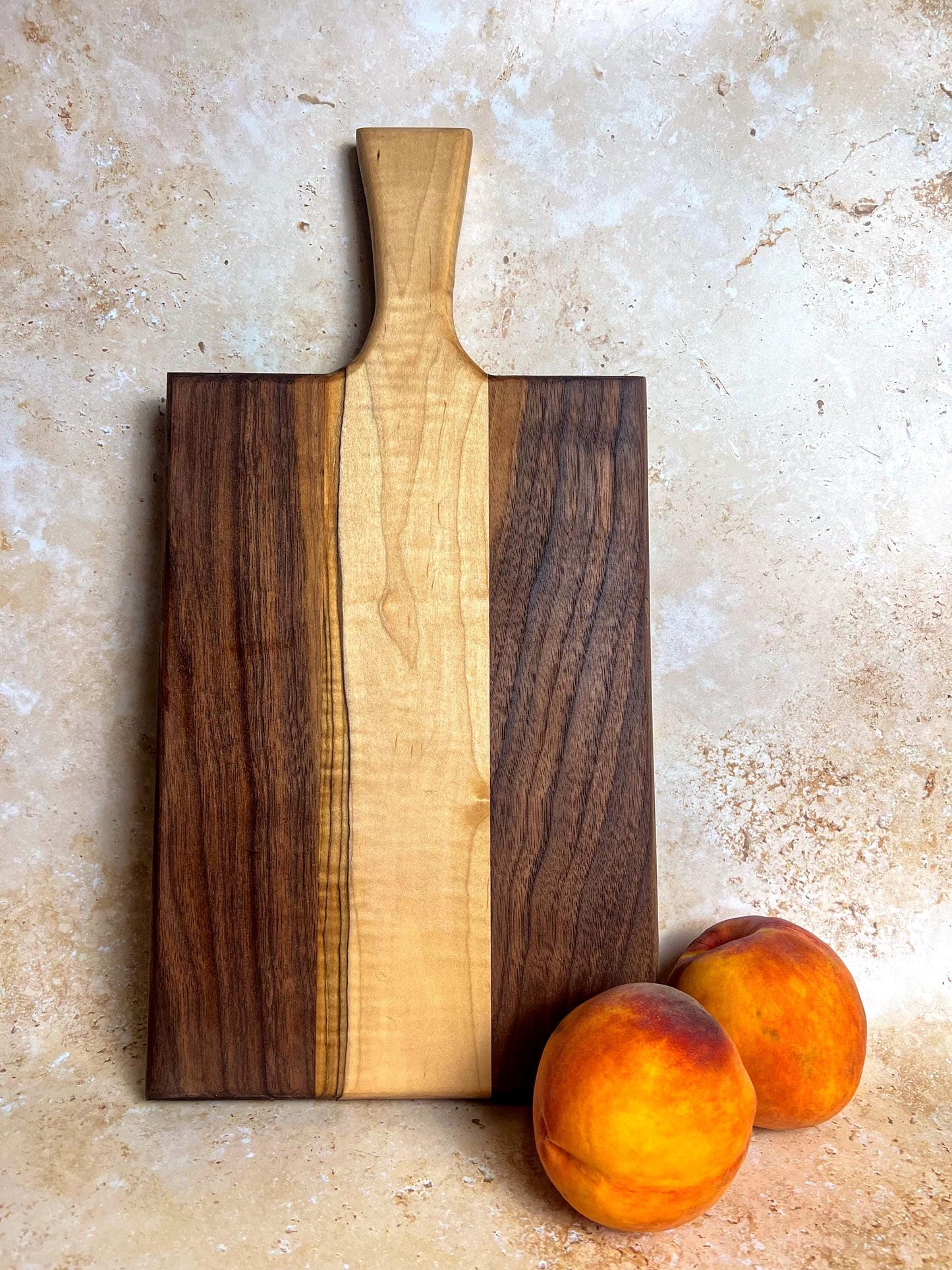 Walnut charcuterie board with maple accents